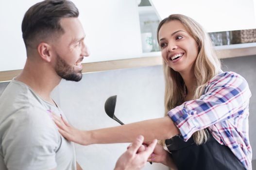 close up. Smiling young couple cooking food in the kitchen