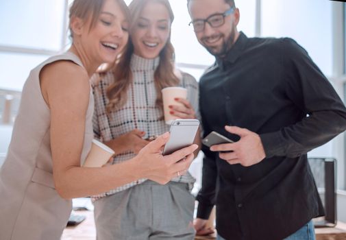 business team reading emails on their smartphones. people and technology