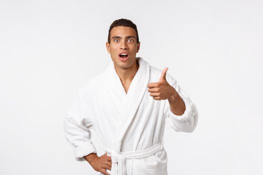 Portrait of happy African American handsome man laughing and showing thumb up gesture