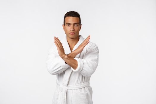 Portrait shock and annoyed displeased young man raising hands up to say no stop right there isolated grey background.