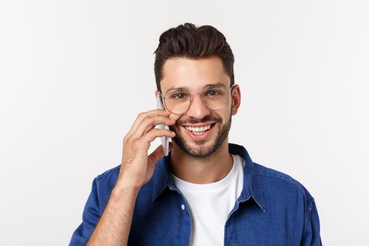 Smiling guy talking on a mobile phone isolated on white background