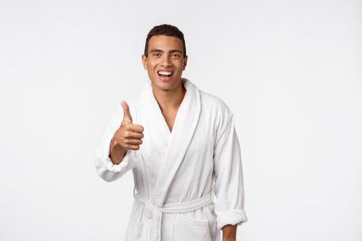 Portrait of happy African American handsome man laughing and showing thumb up gesture