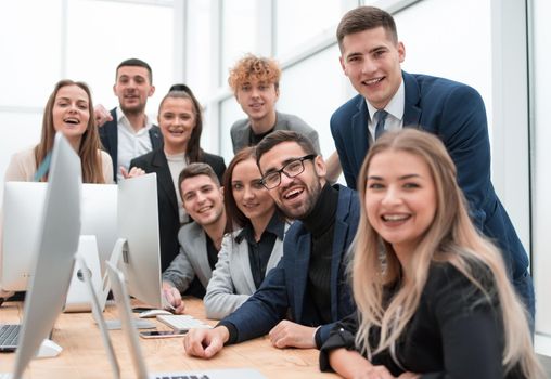 close up.a group of happy employees in the workplace. the concept of teamwork