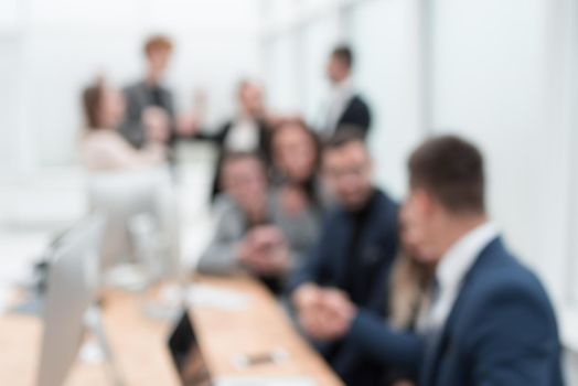 blurry image of a happy business team in the workplace. business background