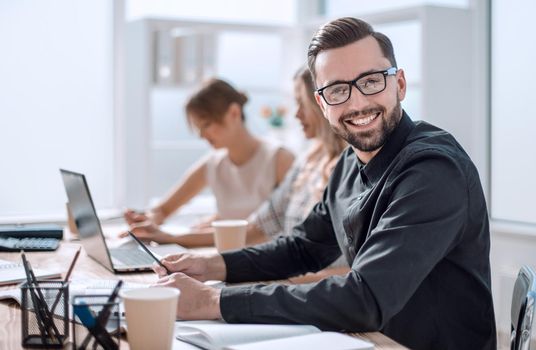 smiling businessman in the workplace in the office. photo with copy space