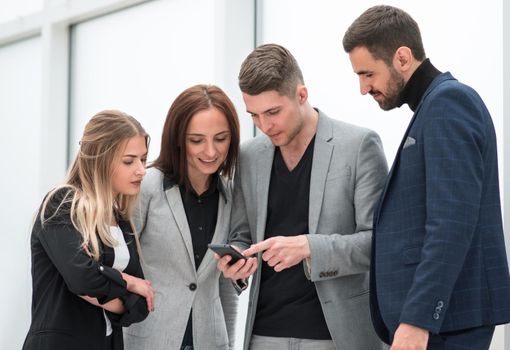 close up. employees reading SMS messages on the smartphone screen