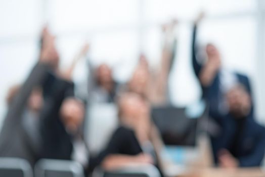 blurry image of a business team sitting at an office Desk. business background