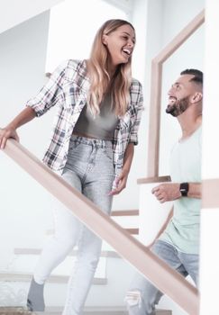 close up. happy couple on the stairs in their new apartment.