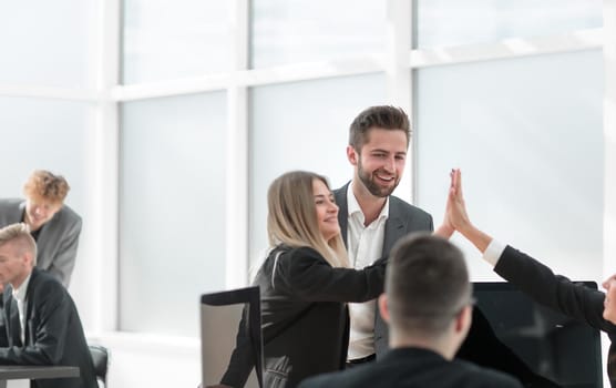 happy employees giving each other a high five. the concept of success.