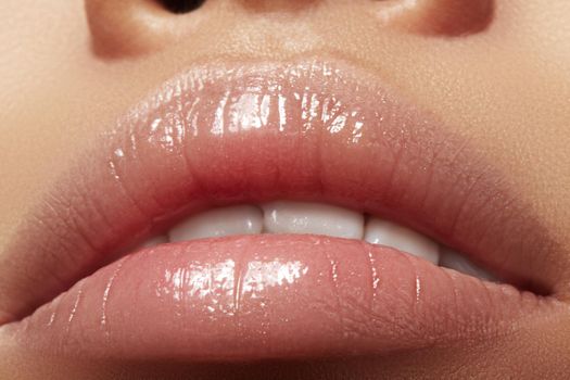 Moisturizing lip balm, lipstick. Close-up of a beautiful sexy wet lips. Nice full lips with gloss lip makeup. Filler Injections, Plastic Surgery, Collagen and Treatments