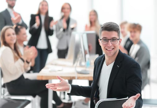 happy businessman sitting near his office Desk. the concept of teamwork