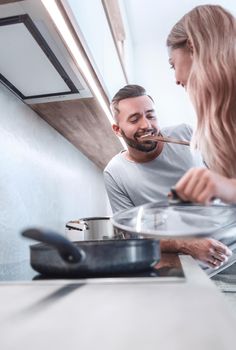 close up. young husband and wife cook dinner together