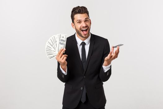 Surprised, speechless and impressed handsome caucasian businessman in classic suit showing credit card, say wow, standing white background astonished.