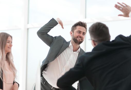 happy employees giving each other a high five. the concept of success.