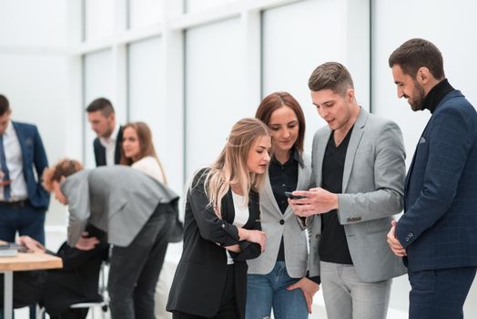 close up. employees reading SMS messages on the smartphone screen