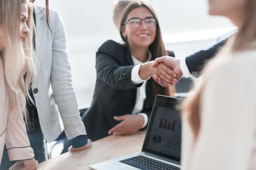 close up. smiling businesswoman shaking hands with her business partner. the concept of cooperation