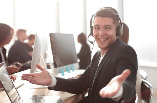 side view. call center operator holding out his hand for a handshake.