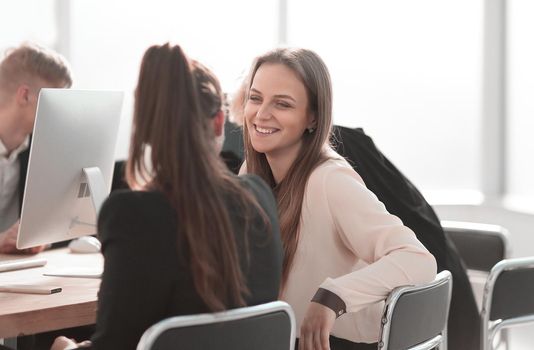 young employees discussing something at the Desk. business concept