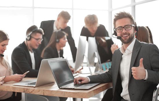 close up. businessman in a headset sitting at an office Desk. the concept of teamwork