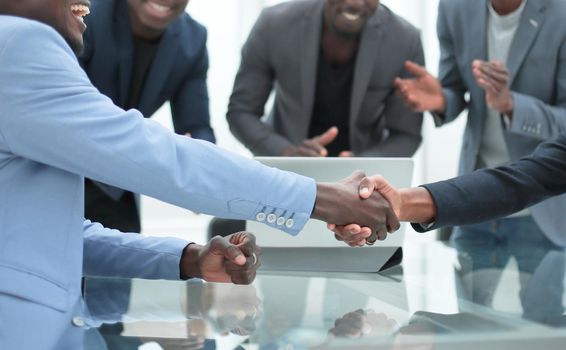 reliable handshake of business partners over the desktop. the concept of cooperation