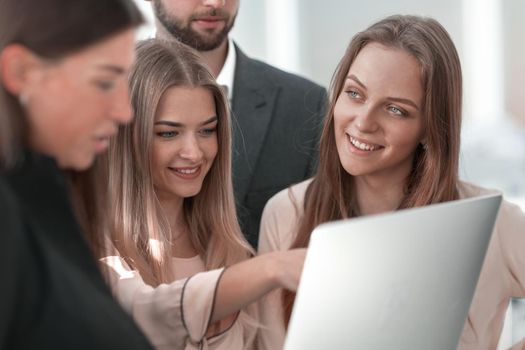 close up. business team looks at the laptop screen together.