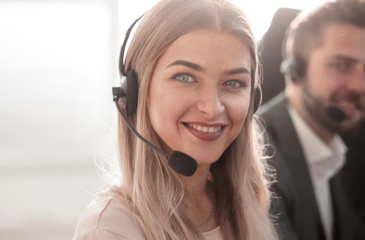 close up. young call center operators on the background of her colleagues