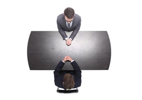 top view. business partners sitting at the Desk. isolated on white background