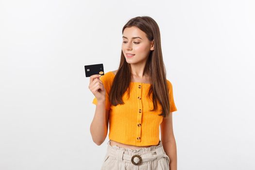 beautiful friendly smiling confident girl showing black card in hand, isolated over white background