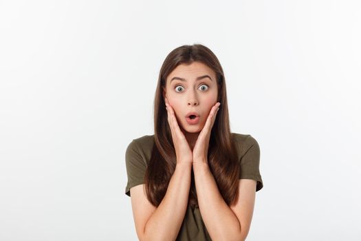 Close-up portrait of surprised beautiful girl holding her head in amazement and open-mouthed. Over white background.