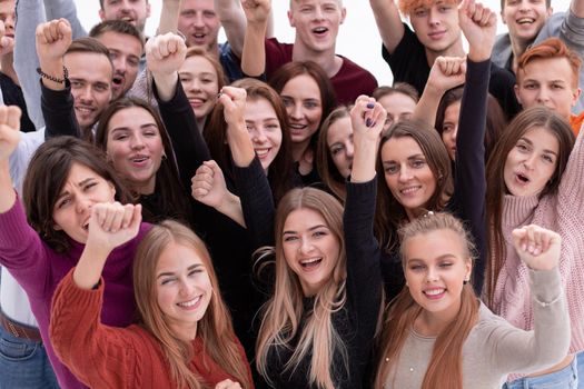 close up. a group of confident young people looking at the camera and showing their success