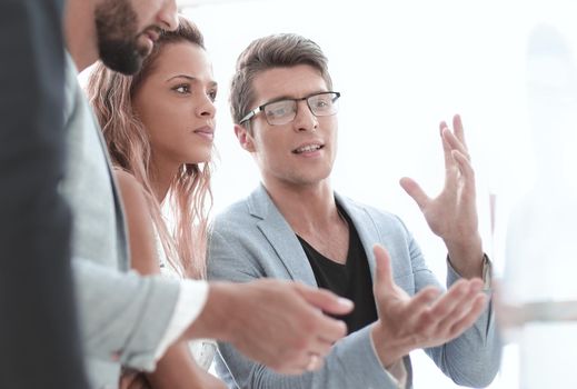 close up.business team talking, standing near the flipchart.photo with copy space