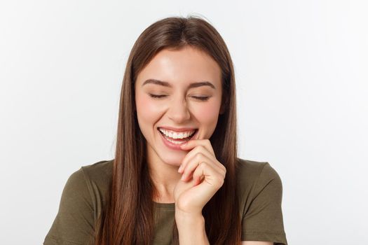 Portrait joyful outgoing woman likes laugh out loud not hiding emotions giggling chuckling facepalm close eyes smiling broadly white background.