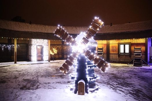 Christmas decoration in the form of a mill on a city street. holiday concept