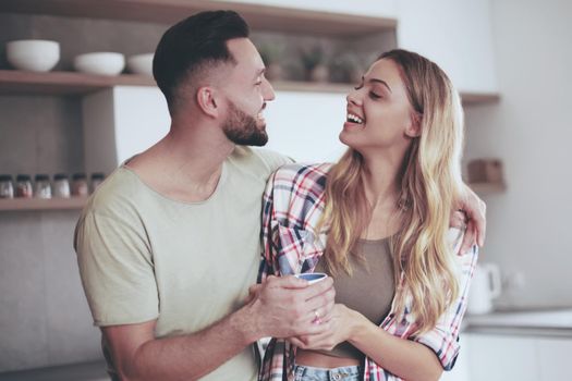 close up. happy young couple in kitchen in good morning time