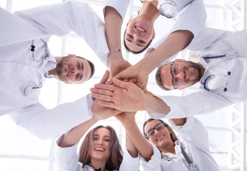 bottom view. a group of diverse medical professionals showing their unity. concept of mutual aid.