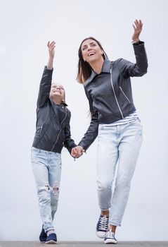 in full growth.happy mother and daughter walking together.photo with copy space