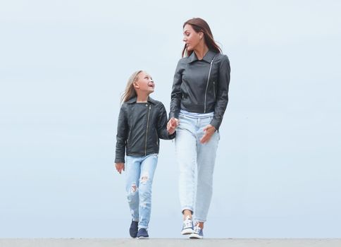 mother holds her daughter's hand tightly. photo with copy space