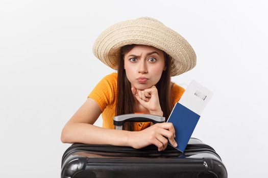 Lifestyle and travel Concept: Young beautiful caucasian woman is sitting on suitecase and waiting for her flight.Isolated over white background.