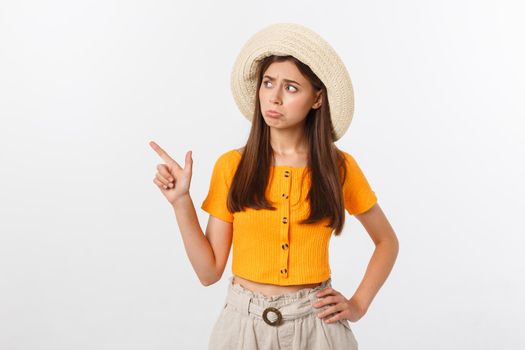 young pretty woman looking unhappy and stressed, suicide gesture making gun sign with hand, pointing to copy space