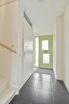 Closed white door of room located near stairway at home