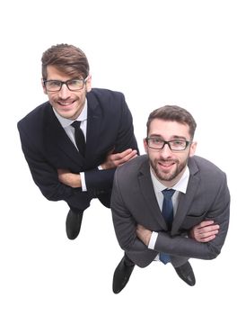 top view . two smiling businessmen looking at the camera . isolated on white background