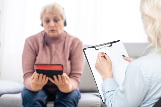 Psychologist comforting a depressed woman during a mental therapy session at the office, lady need of professional help.