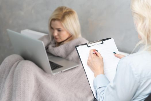 Elegant female woman using portable computer, session with psychologist.