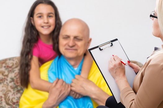 psychologist and little girl with ukraine flag.