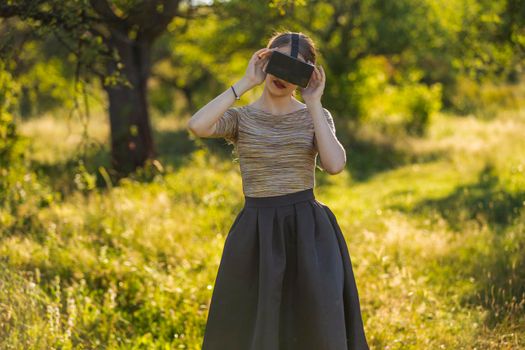 girl with virtual reality gadget in nature