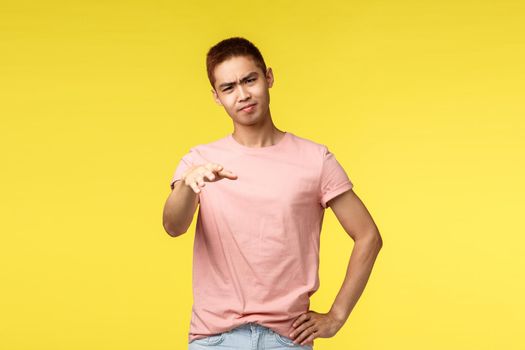 People, different emotions and lifestyle concept. Portrait of skeptical asking guy judging, express negative opinion, frowning and shaking head displeased, gesturing asking to stop or quit.