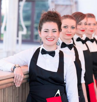 group of waiters at a prestigious restaurant standing in the column in the lobby of the restaurant