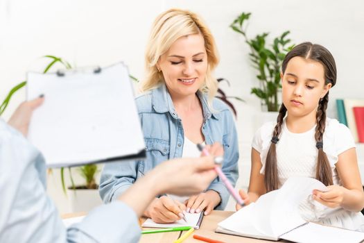 Psychologist working with teenage girl in office.