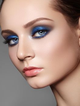 Beautiful Woman with Professional Makeup. Celebrate Style Eye Make-up, Perfect Eyebrows, Shine Skin. Bright Fashion Look. Blue Color of Eyeshadows. Christmas Winter Image