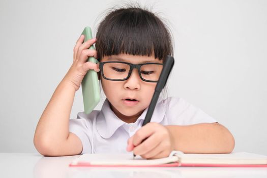 Little business woman with laptop working in office while talking on the phone Children and business concepts